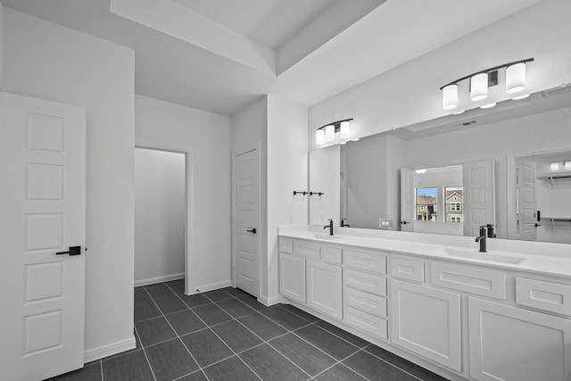 bathroom with tile patterned flooring and vanity