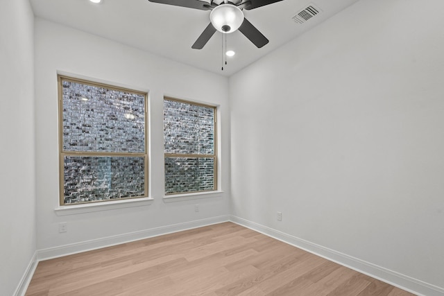 spare room with ceiling fan and light wood-type flooring