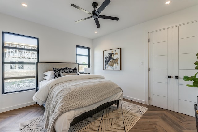 bedroom with dark parquet floors and ceiling fan