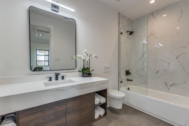 full bathroom with vanity, tile patterned flooring, toilet, and tiled shower / bath