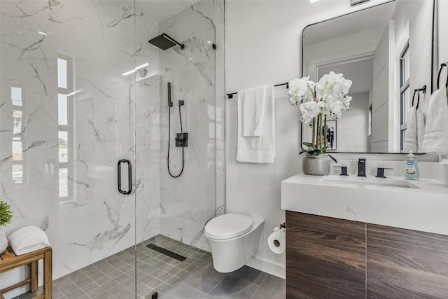 bathroom featuring a shower with door, vanity, and toilet