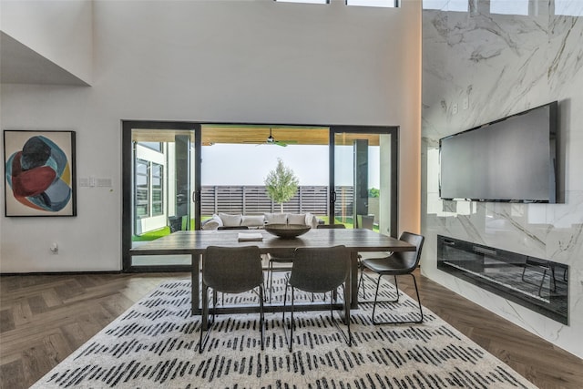 dining area with parquet floors and a towering ceiling