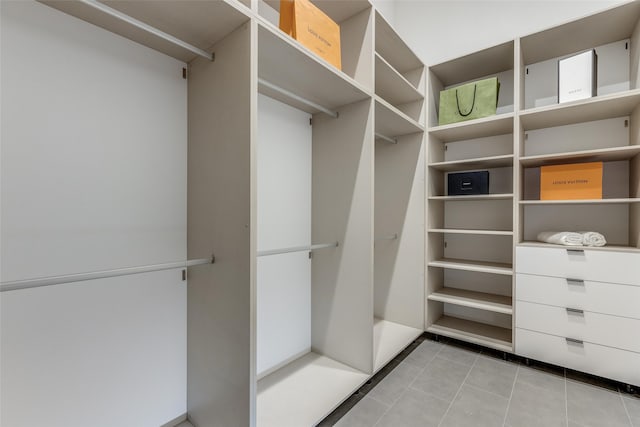 walk in closet featuring light tile patterned floors