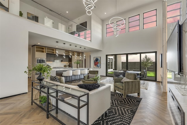 living room with light parquet flooring and a high ceiling