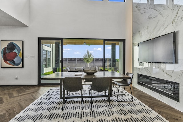 dining room with parquet floors and a high ceiling