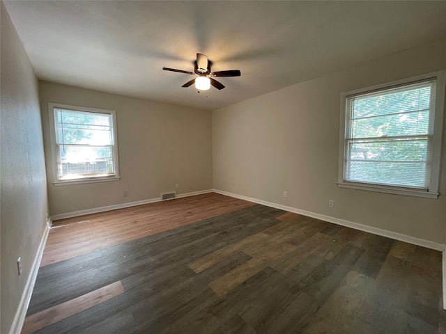 empty room featuring ceiling fan and dark hardwood / wood-style floors