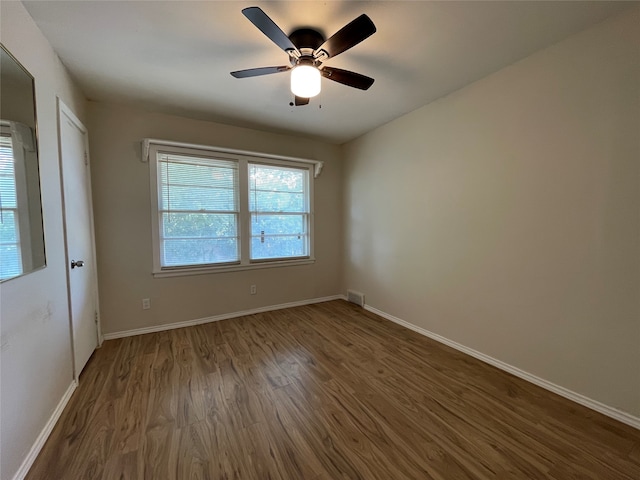 empty room with wood-type flooring and ceiling fan