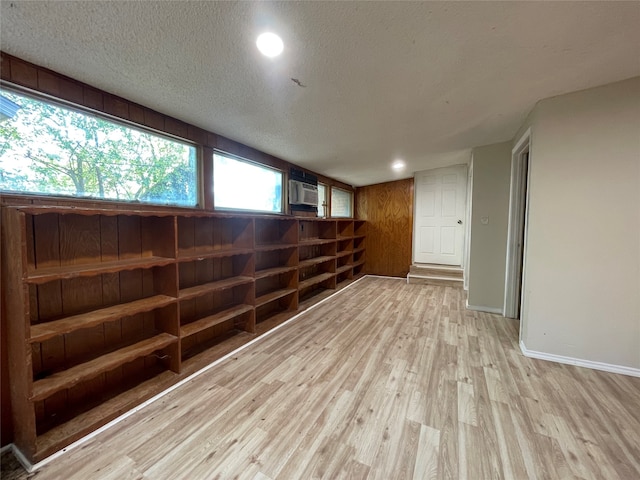 unfurnished room featuring a textured ceiling and light hardwood / wood-style floors