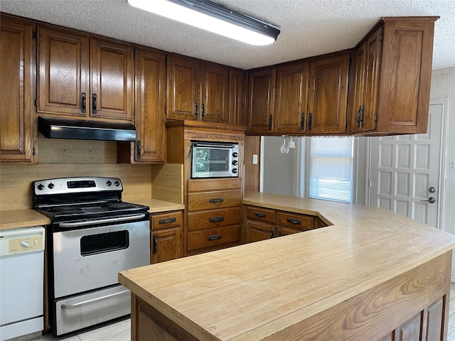 kitchen with a textured ceiling, appliances with stainless steel finishes, and kitchen peninsula