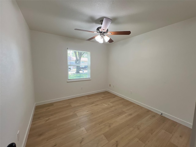 unfurnished room with ceiling fan and light wood-type flooring