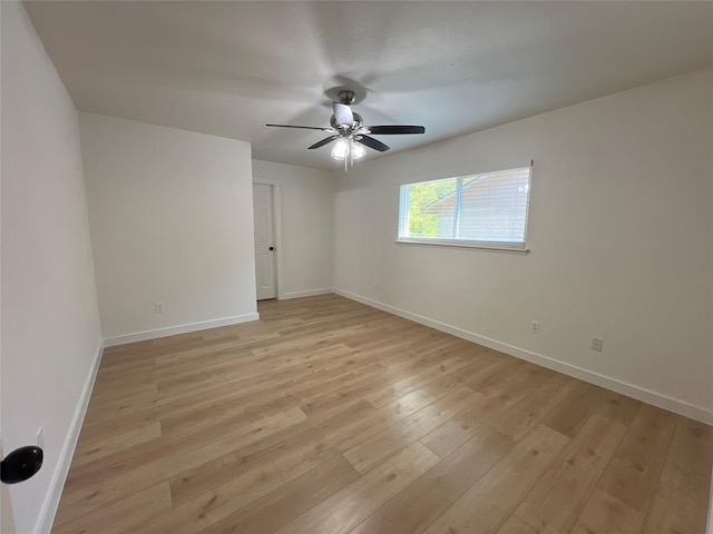 spare room featuring ceiling fan and light hardwood / wood-style flooring