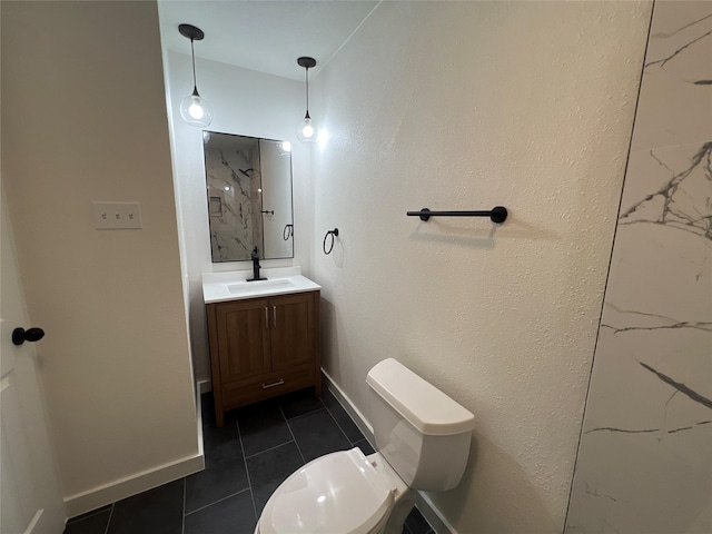 bathroom with tile patterned flooring, vanity, and toilet