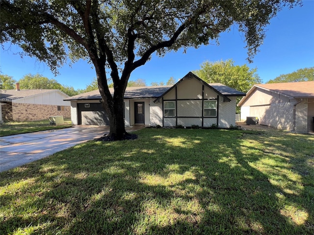 ranch-style home featuring a garage and a front yard