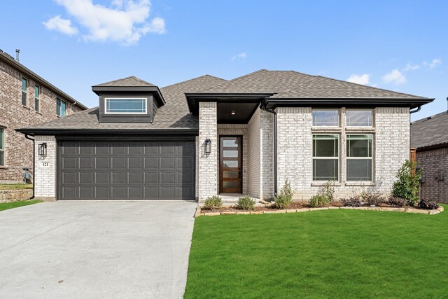 view of front of property with a front lawn and a garage