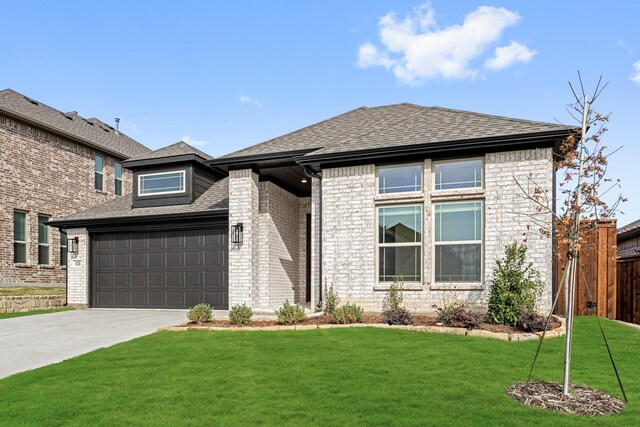 view of front facade featuring a garage and a front lawn