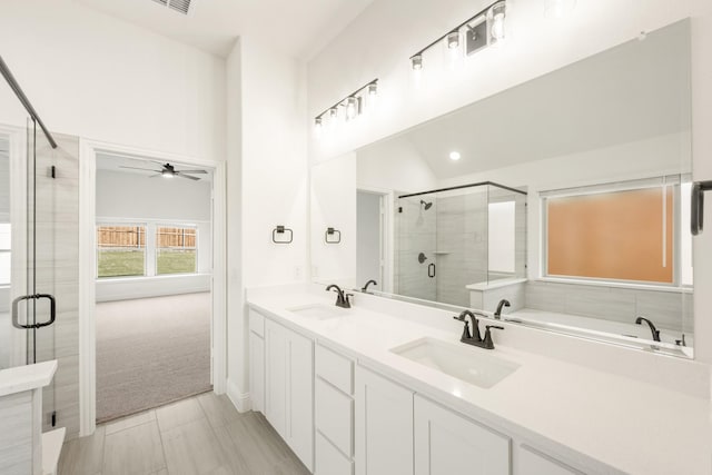 bathroom with vanity, separate shower and tub, ceiling fan, and lofted ceiling