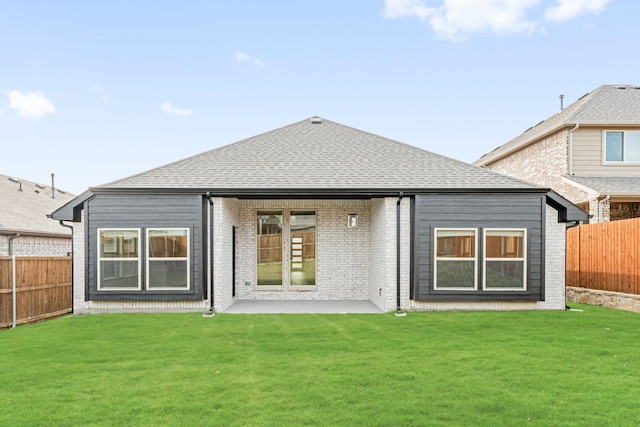 back of property featuring a yard and a patio area