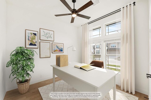 office space with ceiling fan and light hardwood / wood-style flooring