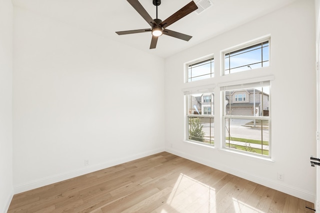 empty room with ceiling fan and light wood-type flooring