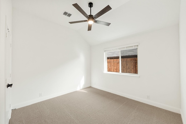 carpeted spare room with ceiling fan and lofted ceiling