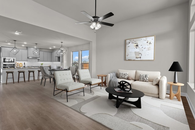 living room featuring a ceiling fan, wood finished floors, and recessed lighting