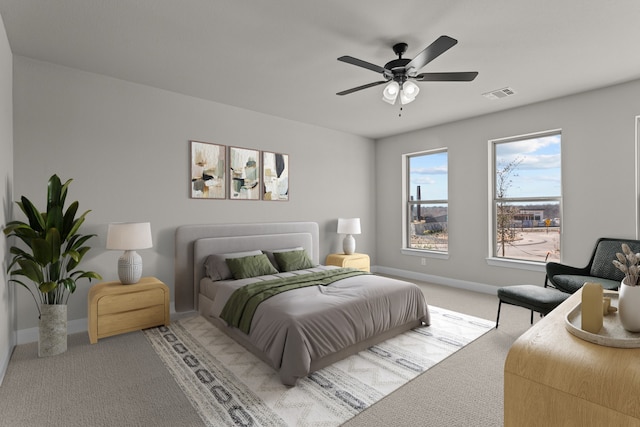 bedroom featuring visible vents, ceiling fan, light carpet, and baseboards