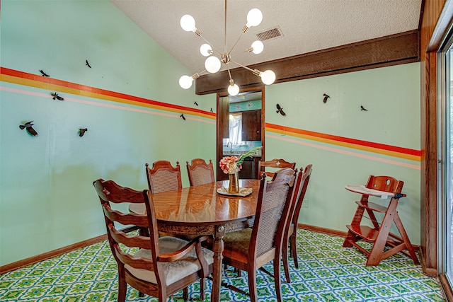 dining area with a textured ceiling, lofted ceiling, and a notable chandelier