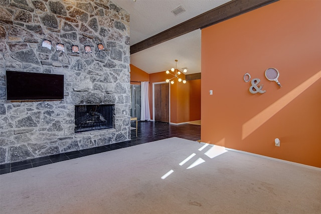 unfurnished living room featuring dark carpet, a textured ceiling, beam ceiling, a chandelier, and a stone fireplace