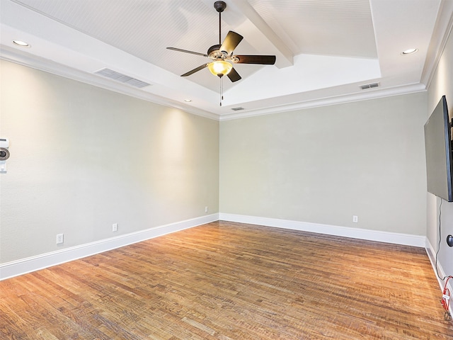 spare room featuring wood-type flooring, ornamental molding, lofted ceiling with beams, and ceiling fan