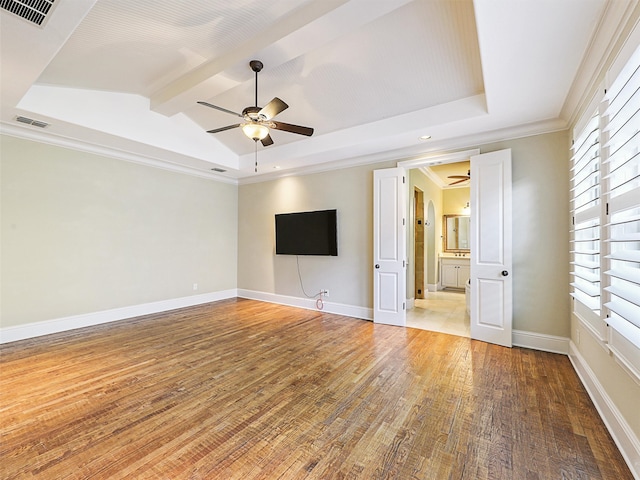 unfurnished living room featuring ornamental molding, lofted ceiling with beams, ceiling fan, and hardwood / wood-style floors