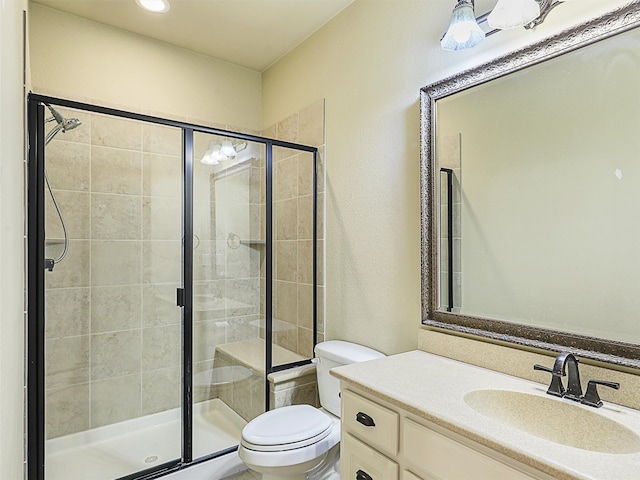 bathroom with vanity, walk in shower, and toilet