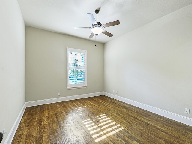 unfurnished room with dark hardwood / wood-style floors and ceiling fan