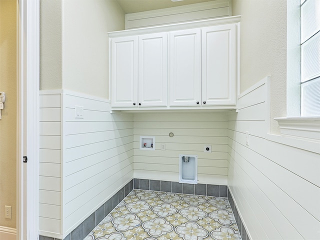 washroom featuring hookup for a washing machine, cabinets, light tile patterned floors, and electric dryer hookup