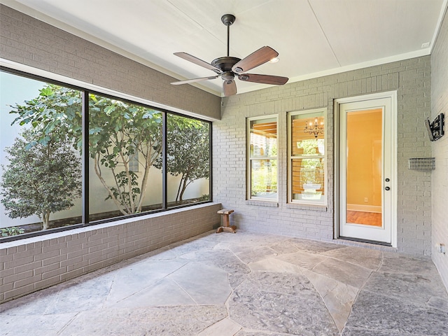 unfurnished sunroom with ceiling fan