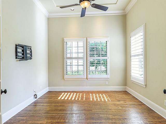 spare room with hardwood / wood-style flooring, crown molding, and a wealth of natural light