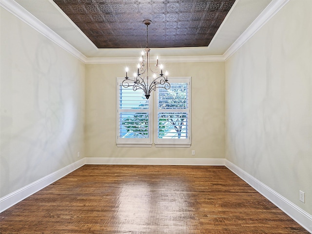 unfurnished dining area featuring a notable chandelier, dark hardwood / wood-style floors, and ornamental molding