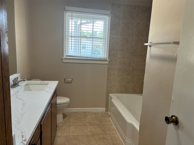 bathroom with vanity, tile patterned flooring, toilet, and a bath