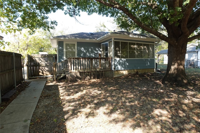 rear view of house featuring a sunroom