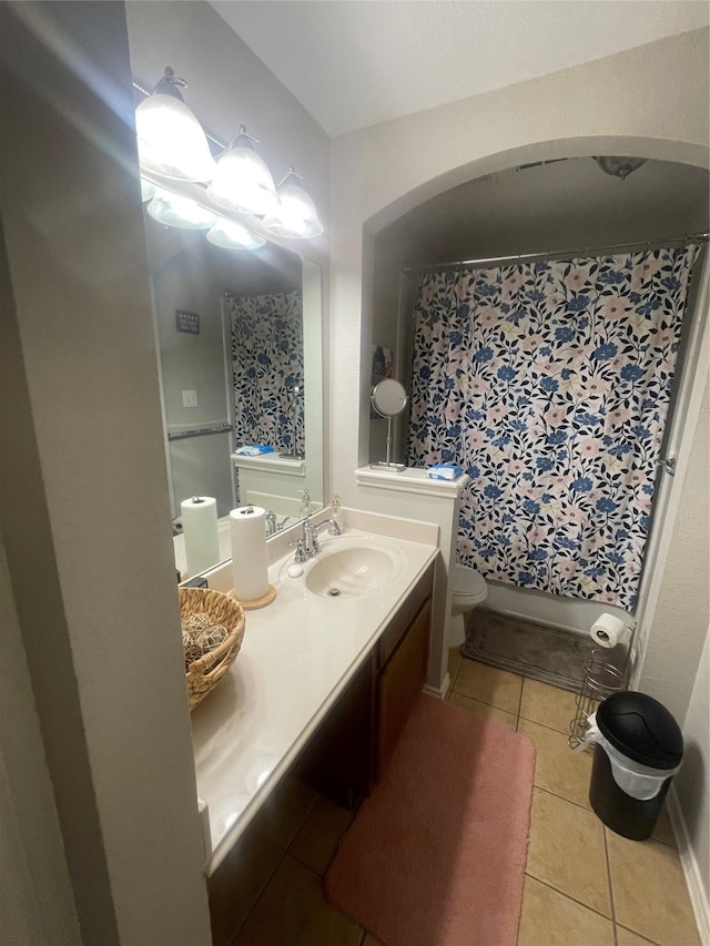 bathroom featuring tile patterned floors, a shower with curtain, vanity, and toilet