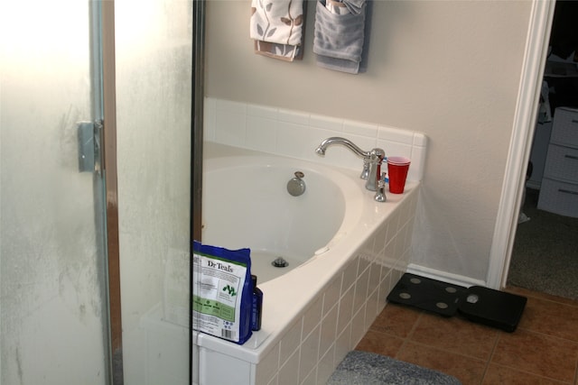 bathroom with independent shower and bath and tile patterned flooring