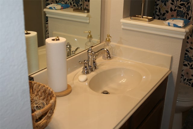 bathroom featuring vanity and toilet