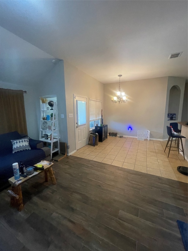 living room with a notable chandelier and hardwood / wood-style floors