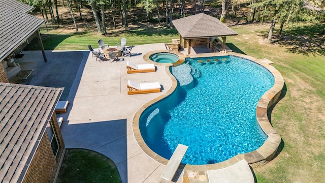 view of pool with a lawn, an in ground hot tub, a fire pit, and a patio