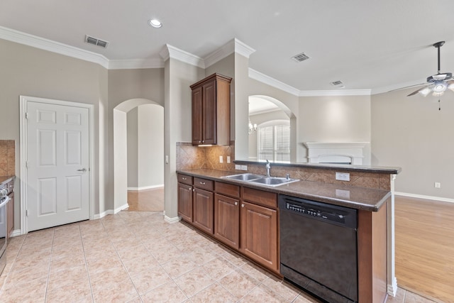 kitchen featuring dishwasher, a sink, visible vents, and decorative backsplash