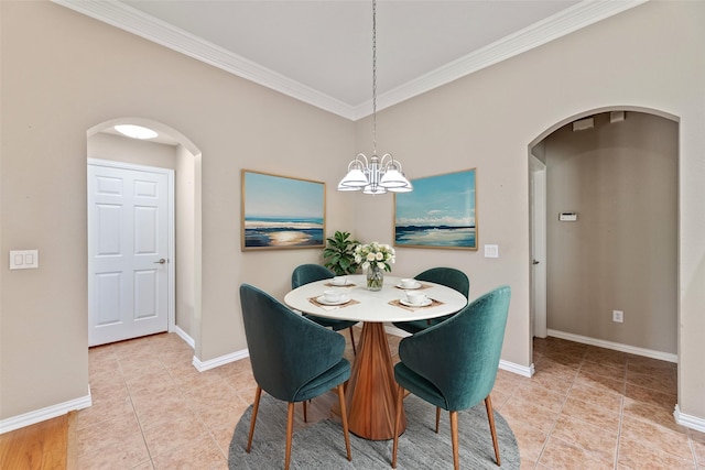 dining space with a chandelier, arched walkways, crown molding, and baseboards