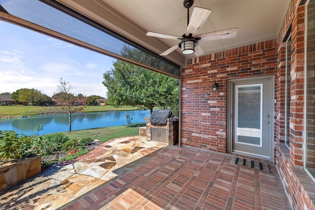 view of patio with a water view, ceiling fan, and area for grilling