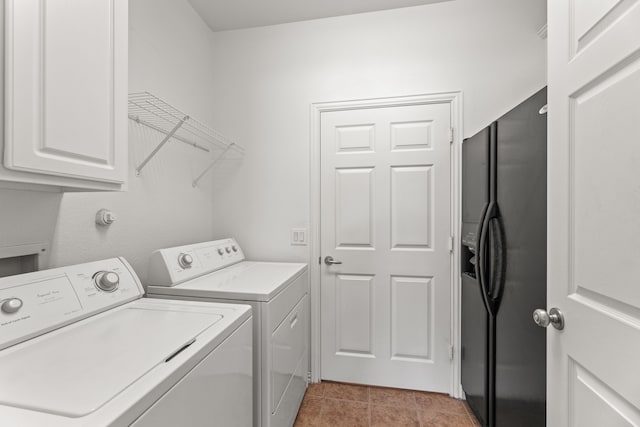 washroom with light tile patterned floors, cabinet space, and separate washer and dryer