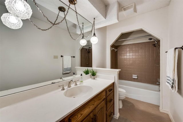 full bathroom featuring tile patterned flooring, vanity, toilet, and tiled shower / bath