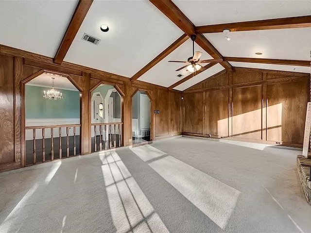 interior space with beamed ceiling, ceiling fan with notable chandelier, light colored carpet, high vaulted ceiling, and wooden walls