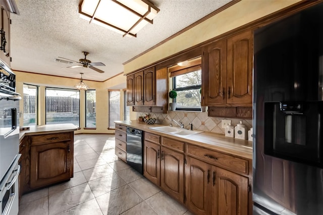 kitchen featuring appliances with stainless steel finishes, backsplash, a textured ceiling, and sink